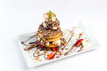 Isolated pancakes dessert with ice cream chocolate and fruits