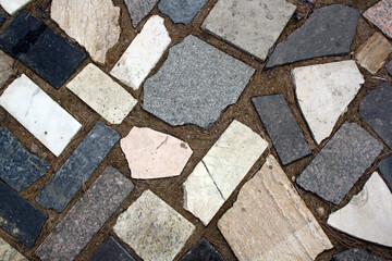 Background from fragments of granite stone on the sand.