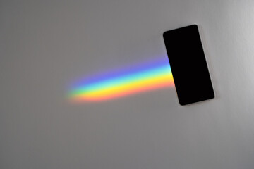 A Blank phone with a rainbow trail - Powered by Adobe