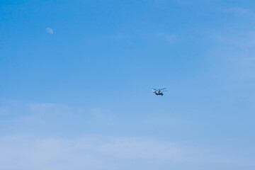 A helicopter flying across the sky