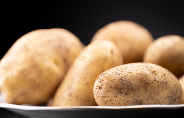 Unpeeled potato is on a plate