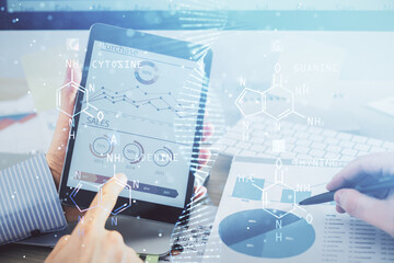 Double exposure of man's hands holding and using a phone and DNA drawing. Medical education concept.