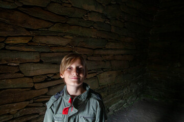 A boy in front of a wall