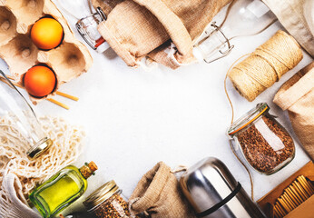 Zero waste, plastic free and sustainable lifestyle concept. Recyclable, reusable eco friendly bags, package, bottles, cans and storage containers, mesh bag. White background, copy space, top view