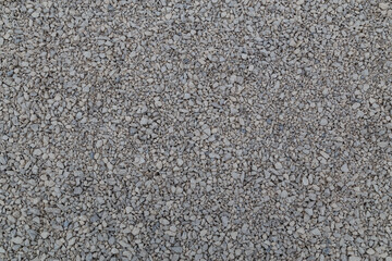 Dry white limestone ballast flat full frame background. Small gray dusty broken macadam stones...
