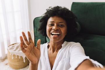 African woman waving hand on video call