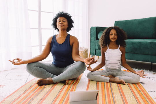 Grand mother and grand daughter doing mindful meditation at home