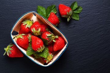 Food concept Fresh organic Strawberry on black slate stone board with copy space