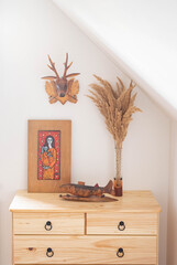 Interior with wooden statues and a picture