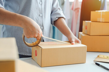female warehouse worker are checking or seller packing ecommerce shipping order box for dispatching, preparing post courier delivery package or online sales, e-commerce concept.