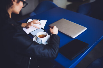 Entrepreneur using smartphone while working in cafe