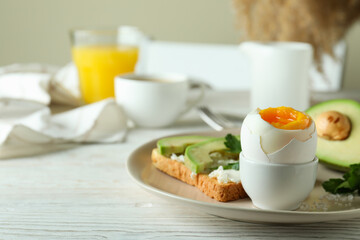 Concept of tasty breakfast with boiled egg, space for text