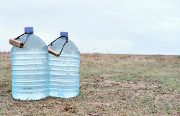 Two large plastic transparent carboys, capacity 5 gallons (19 liter), for water coolers with...
