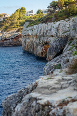 Fototapeta na wymiar Rocky seashore. Steep coast. A steep cliff near the sea. Porto Cristo, Mallorca. Travel Concept. High quality photo