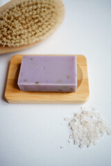 purple soap, brush and salt and on white background