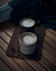 cup of hot latte art coffee on wooden