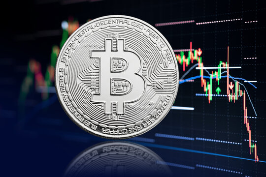 Bitcoin coin and stock chart background with price falling. Cryptocurrency