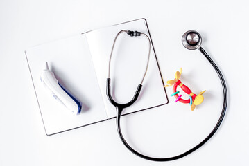 children's doctor work with stethoscope and notebook white background top view mock-up