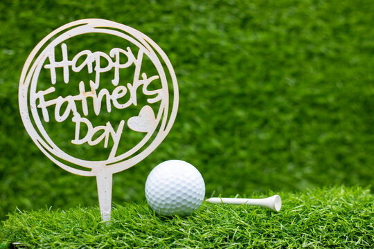 Golf ball with Happy Father's Day are on green grass