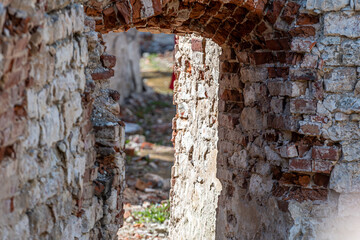 close-up of a fragment of the ruins of an old stone building on a sunny day, defocused background