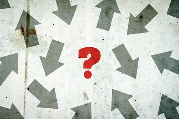 Arrows in different directions on a concrete wall. Red question mark. Concept of choosing the right path. Business. Lifestyle.