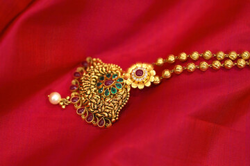 golden necklace on silk