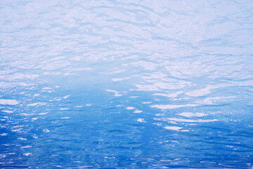 Obraz premium Surface of blue swimming pool. Under water. Background of blue ripped water in swimming pool