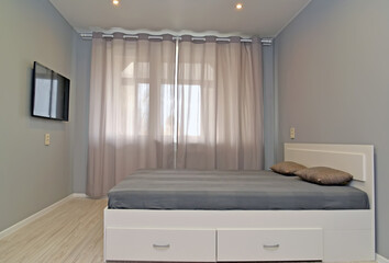 Bedroom with curtained window