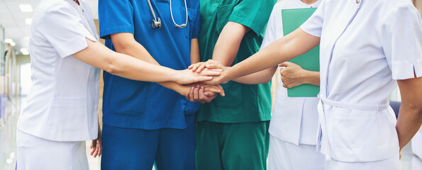Cooperation of people in the medical community teamwork with a hands together between the doctor in...