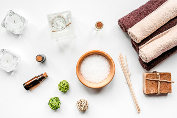 Fototapeta na wymiar spa cosmetics with soap, salt, oil on white background top view