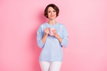 Photo of charming lady hands hold coffee smile look camera wear sweater isolated on pink color background