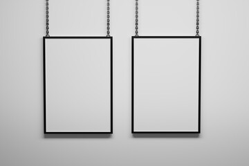 Two A4 vertical frames hanging on metallic chains