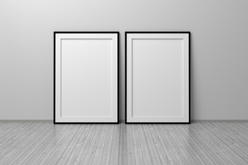 Two A4 blank vertical frames standing on wooden reflective floor
