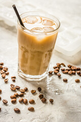 iced coffee with beans for cold summer drink on stone background
