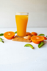 Orange juice and fresh orange fruits On a white wooden background