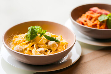 Tagliatelle with rabbit meatballs. Meatballs in a creamy sauce with pasta. Pasta with meat and parmesan cheese. Spaghetti with meat balls and parmesan. Italian pasta for lunch. Pasta in a bowl. Dinner