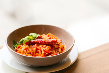 Pasta with meatballs, tomatoes and chili. Pasta with parmesan and basil. Spicy tomato and chili pasta. Chili spaghetti. A bowl of spaghetti. Pasta in tomato sauce. A bowl of junk food. Dinner