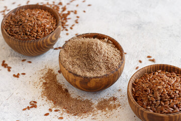 Raw Flax seeds flour and seeds in bowls