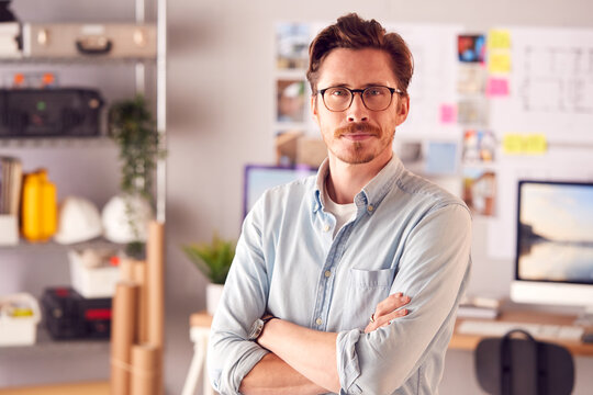 Portrait Of Serious Male Architect In Office Standing By Desk