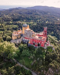 Aerial view of Pena Palace, a hilltop Romanticist palace in parkland at sunset, Sintra, Lisbon, Portugal.