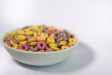 A bowl of colourful cereal isolated on white