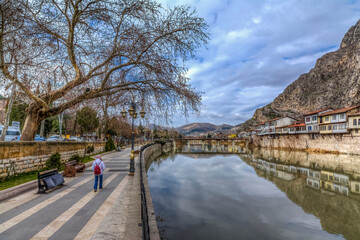 Fototapeta na wymiar Old Ottoman houses evening panoramic view by the Yesilirmak River in Amasya City. Amasya is populer tourist destination in Turkey.