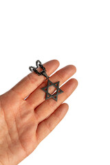 A hand holding a Star of David Necklace isolated on white 