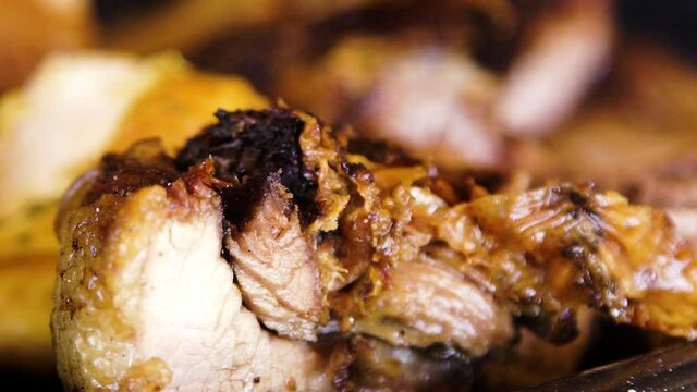 Typical barbecue, parrillada, with pork meat and potatoes in Argentina, close up