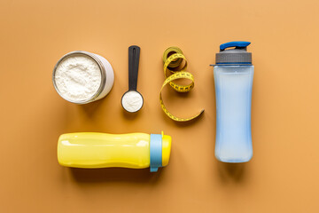 Sport protein shake smoothie in bottle with gym accessories