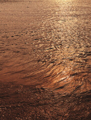 Rippled blurred texture of water. Blue water surface texture.
