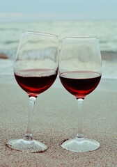 two glasses of wine on the beach