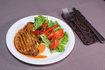 Pepper steak with grilled vegetables on a table in a restaurant. Oriental cuisine