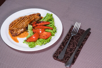 Pepper steak with grilled vegetables on a table in a restaurant. Oriental cuisine