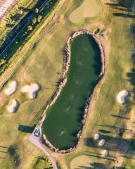 Aerial view of the golf court with a small lake in the field, view of the country sport club in Cruz Quebrada-Dafundo, Lisbon, Portugal.